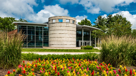 Hatfield Hall from the outside with colorful flowers in the foreground.