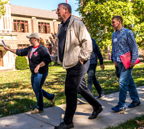 Parents walk across campus with prospective students during a campus tour.
