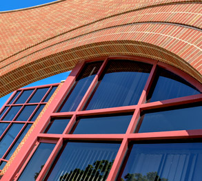 Image shows the brick arch and the tinted windows of New Olin Hall.